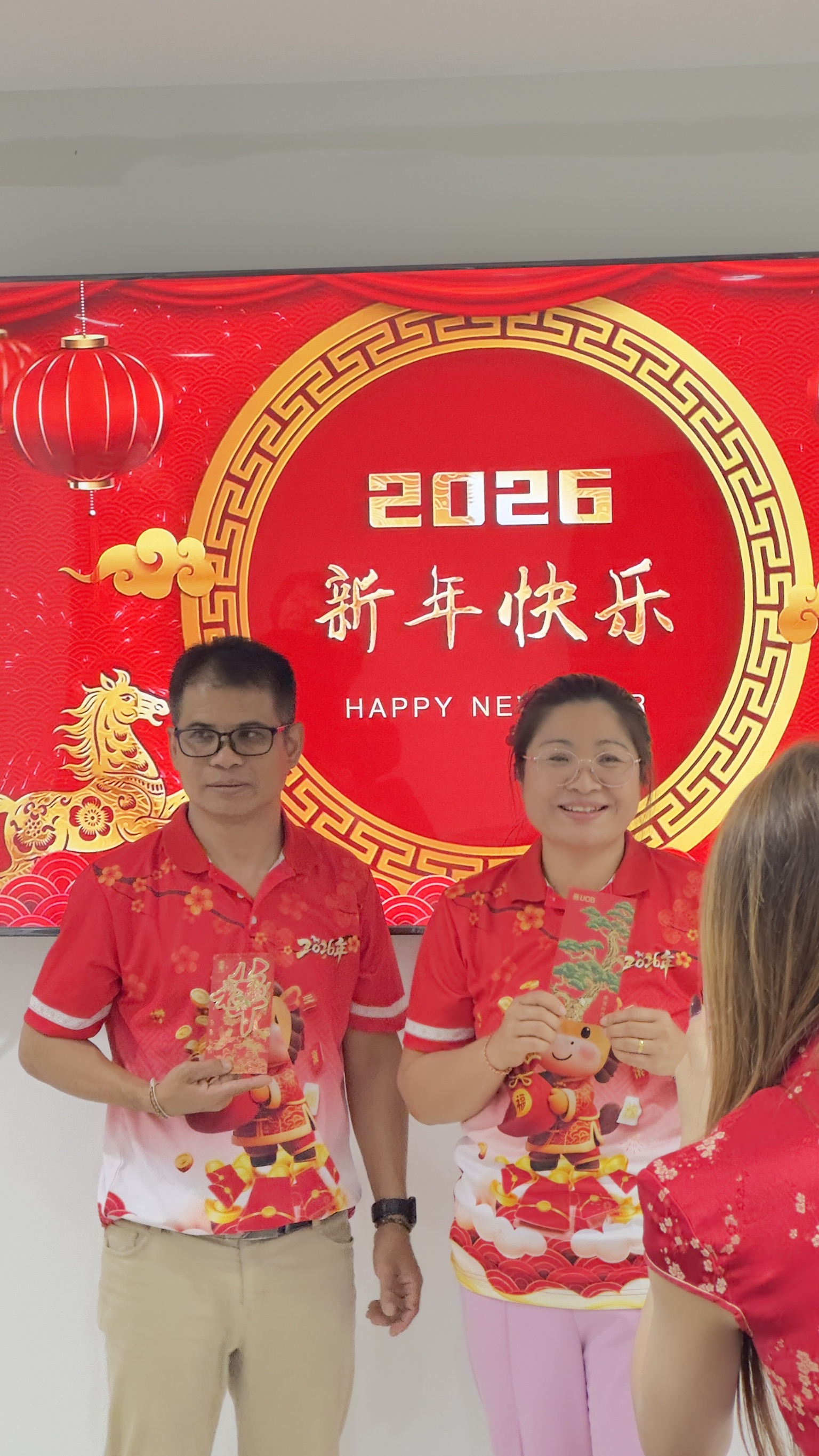 Celebrating Chinese New Year 2026 at MingDeng Thailand 2 Employees holding red envelopes Chinese New Year Thailand